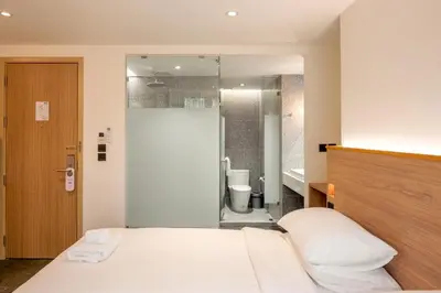 a hotel room with a bed and a bathroom at ZEN MASTER HOTEL in Bangkok