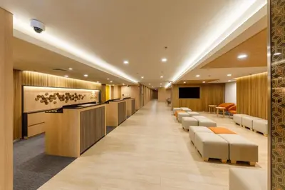 a waiting room at a hospital with a row of chairs at Nishitetsu Hotel Croom Bangkok Silom in Bangkok