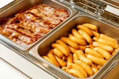a tray of food with pasta and meat at Nishitetsu Hotel Croom Bangkok Silom in Bangkok