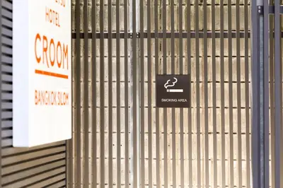 a sign on the side of a metal wall at Nishitetsu Hotel Croom Bangkok Silom in Bangkok
