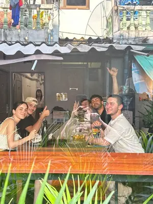 a group of people sitting at a table at Ti Thong Hostel in Bangkok