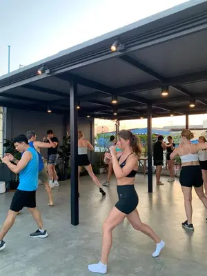 a group of people dancing in a dance class at Ti Thong Hostel in Bangkok
