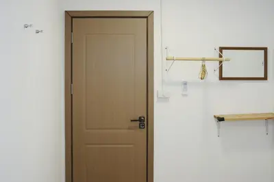 a wooden door in a room with a clipboard at Private Full-Floor Spacious 5BR in China Town in Bangkok