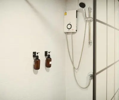 a bathroom with a shower with a soap dispenser at Private Full-Floor Spacious 5BR in China Town in Bangkok