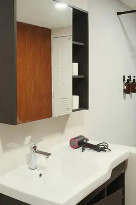 a bathroom sink with a hair dryer and a mirror at Private Full-Floor Spacious 5BR in China Town in Bangkok