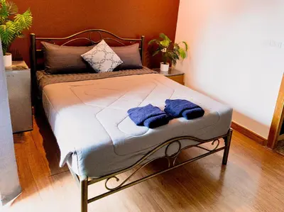 a bed with two towels on it in a room at Guesthouse Bangkok BM B&B in Bangkok
