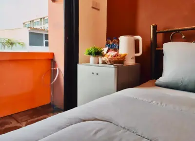 a bedroom with a bed and a window at Guesthouse Bangkok BM B&B in Bangkok