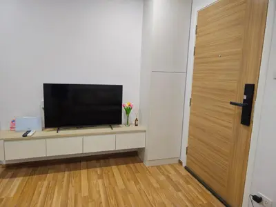 a flat screen tv sitting on a cabinet in a room at Sukhumvit​ 101 in Phra Khanong