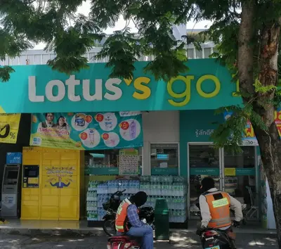 two people on motorcycles in front of a store at Sukhumvit​ 101 in Phra Khanong