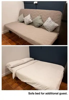 a bed with a white blanket and pillows on it at A2 Comfortable space wt Kitchen in Bangkok
