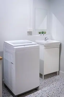 a white bathroom with two sinks and a mirror at A3 Large Room, Full Facilities in Bangkok