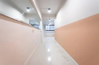 a long hallway with white walls at A3 Large Room, Full Facilities in Bangkok