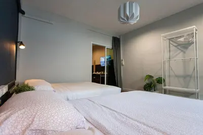 a bedroom with two beds and a window at A3 Large Room, Full Facilities in Bangkok