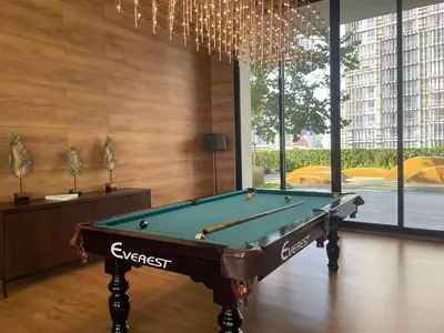 a room with a pool table and a chandelier at Luxurious Apartment in Sukhumvit in Bangkok