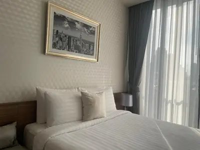 a hotel room with a bed and a window at Luxurious Apartment in Sukhumvit in Bangkok