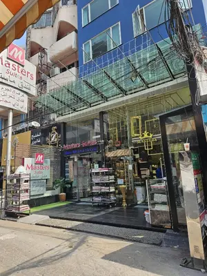 a store front of a building with a window at Masters Suites Hotel in Makkasan