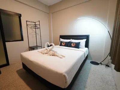 a bedroom with a bed with two swans on it at Dancenter Rq Bangkok Huai Khwang in Bangkok