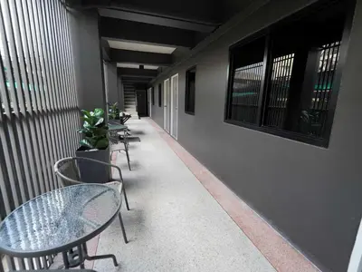 a corridor with tables and chairs on a building at Dancenter Rq Bangkok Huai Khwang in Bangkok