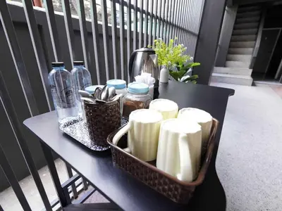 a black table with containers and bottles on a balcony at Dancenter Rq Bangkok Huai Khwang in Bangkok