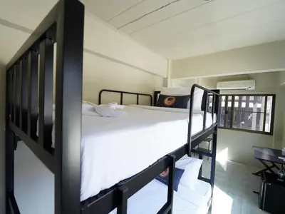 a bedroom with a bunk bed with white sheets at Dancenter Rq Bangkok Huai Khwang in Bangkok