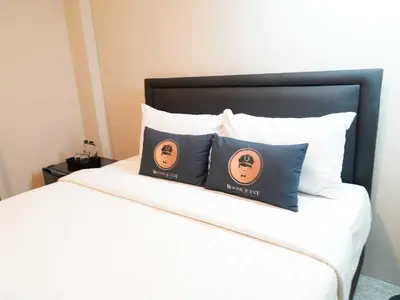 two pillows sitting on top of a bed at Dancenter Rq Bangkok Huai Khwang in Bangkok