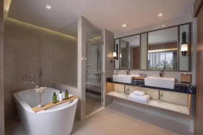 a bathroom with two sinks and a bath tub at Nysa Hotel Bangkok Sukhumvit 11 in Bangkok