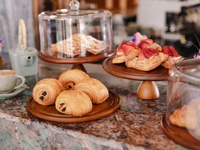 two plates of pastries are sitting on a counter at Nysa Hotel Bangkok Sukhumvit 11 in Bangkok