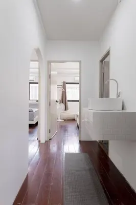 a white bathroom with a sink and a mirror at 4BR entire house next to Skytrain BTS and Subway MRT Chatuchak in Bang O