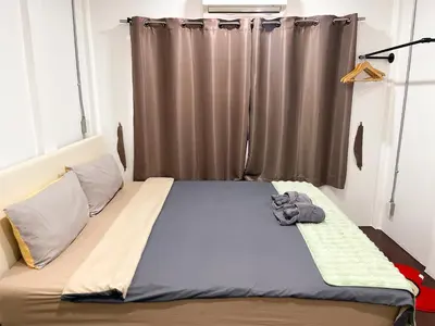 a bed in a room with a window at 4BR entire house next to Skytrain BTS and Subway MRT Chatuchak in Bang O