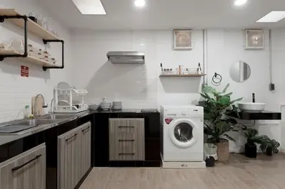 a kitchen with a washing machine and a dishwasher at 4BR entire house next to Skytrain BTS and Subway MRT Chatuchak in Bang O