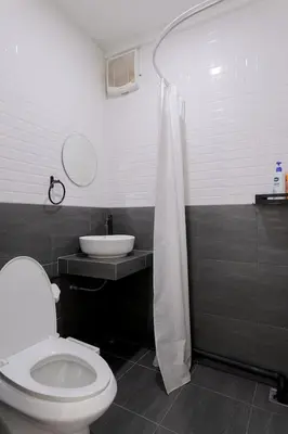 a bathroom with a toilet and a sink and a shower at 4BR entire house next to Skytrain BTS and Subway MRT Chatuchak in Bang O