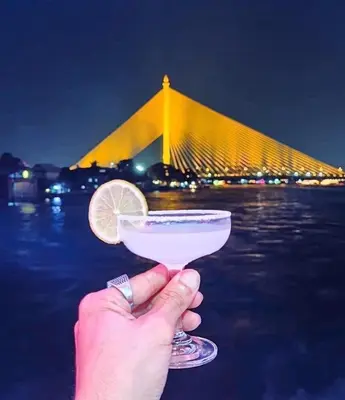 a person holding a drink with a lemon slice at wonderful hostel khaosan in Bangkok