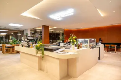 a restaurant with a counter with flowers on it at Saan Hotel Sathorn in Bangkok
