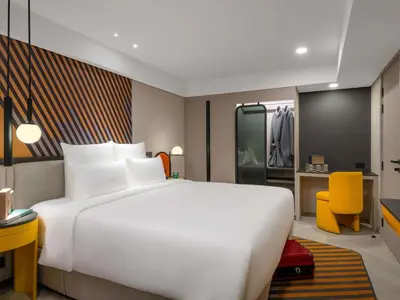 a large white bed in a hotel room at TRIBE Living Bangkok Sukhumvit 39 by AccorHotels in Bangkok