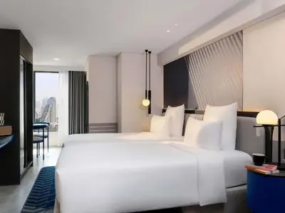 a large white bed in a hotel room at TRIBE Living Bangkok Sukhumvit 39 by AccorHotels in Bangkok