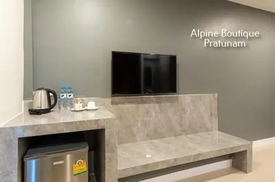 a fireplace with a flat screen tv on top of it at Alpine Boutique Pratunam in Bangkok