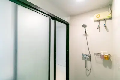 a shower in a bathroom with a glass door at Narastay @ Phrom Phong in Bangkok