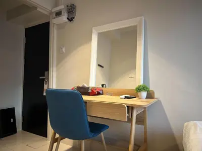 a desk with a blue chair and a mirror at Narastay @ Phrom Phong in Bangkok