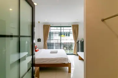 a bedroom with a bed and a window at Narastay @ Phrom Phong in Bangkok