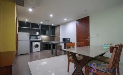 a kitchen with a table and a dining room at Lasalle Park Serviced Apartment at Lasalle 75 in Bangna