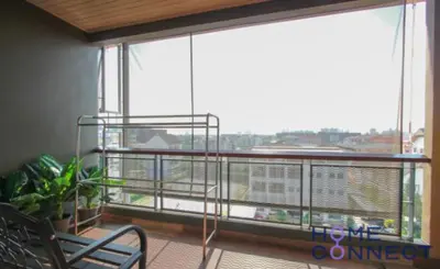 a room with a balcony with a large window at Lasalle Park Serviced Apartment at Lasalle 75 in Bangna