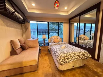 a bedroom with two beds and a couch and a window at \u66fc\u8c37\u72ec\u680bLat Phrao\u7cbe\u54c1\u522b\u5885 in Bangkok