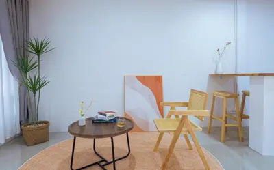 a living room with a table and chairs at Ratchada Retreat Bespoke Urban Villa 3 in Bangkok