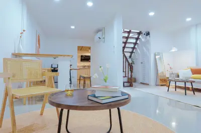 a living room with a table and chairs at Ratchada Retreat Bespoke Urban Villa 3 in Bangkok