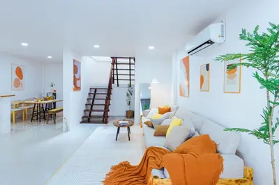 a living room with a couch and a dining room at Ratchada Retreat Bespoke Urban Villa 3 in Bangkok