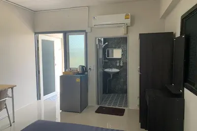a bathroom with a shower and a sink in a room at Na Nont Place in Bangkok