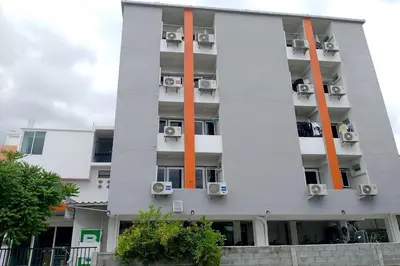 a tall apartment building with air conditioning at Na Nont Place in Bangkok