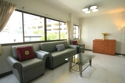 a living room with a couch and a table at Manoo House H in Makkasan