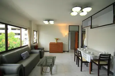 a living room with a couch and a table at Manoo House H in Makkasan