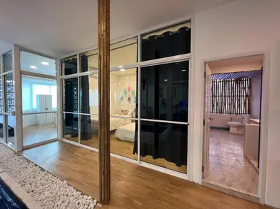 a room with large glass windows and a bedroom at Roof Top 4BR Top Private Floor, china town, center in Bangkok